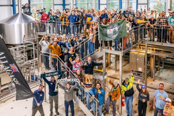 Allagash Brewing staff cheer on their big announcement of their collaboration with Portland Hearts of Pine